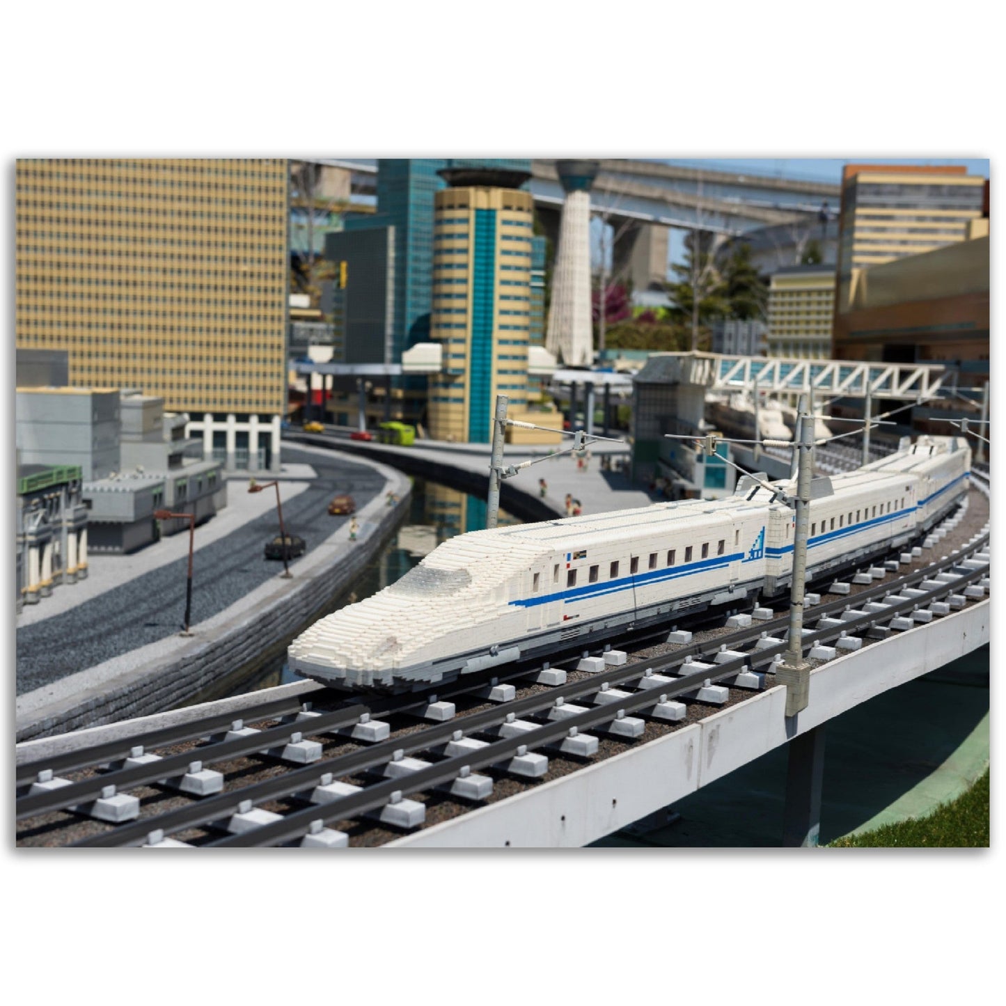 Premium Matte Paper Poster - Nagoya Shinkansen lego model running on railway with city background of Legoland - JAPAN - Green Forest Home