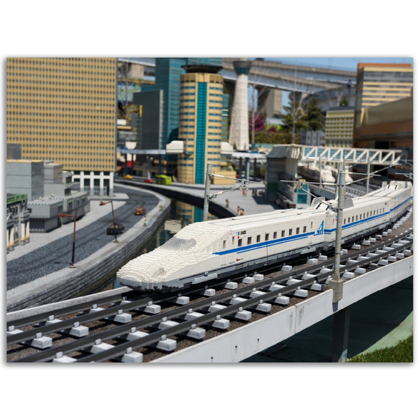 Premium Matte Paper Poster - Nagoya Shinkansen lego model running on railway with city background of Legoland - JAPAN - Green Forest Home