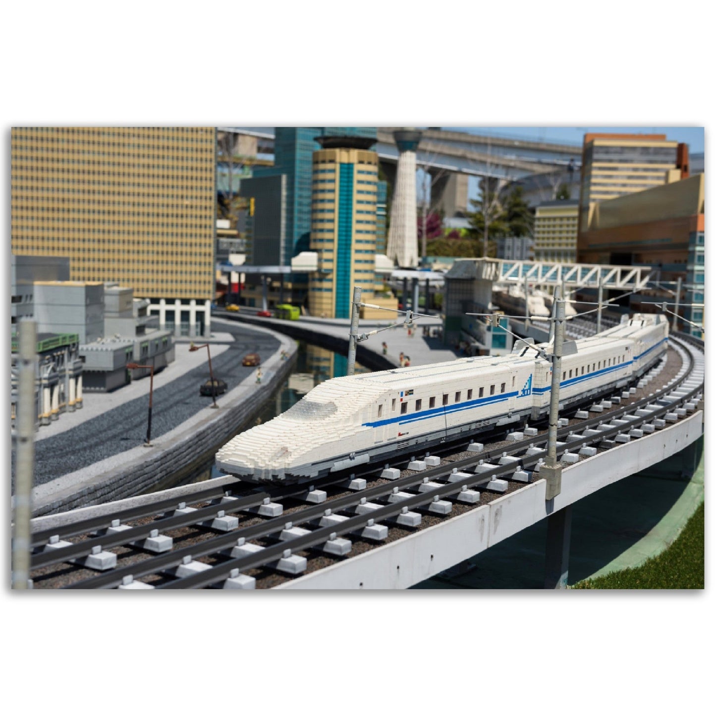 Premium Matte Paper Poster - Nagoya Shinkansen lego model running on railway with city background of Legoland - JAPAN - Green Forest Home